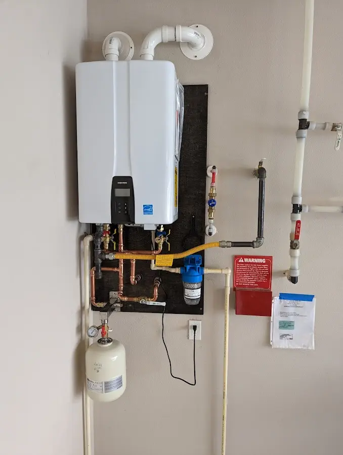 Professional plumber installing copper piping in a Fayetteville home